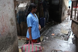 A community worker for SNEHA stands in an alleyway in Dharavi, Mumbai. (Photo credit: SNEHA Stock Photos)